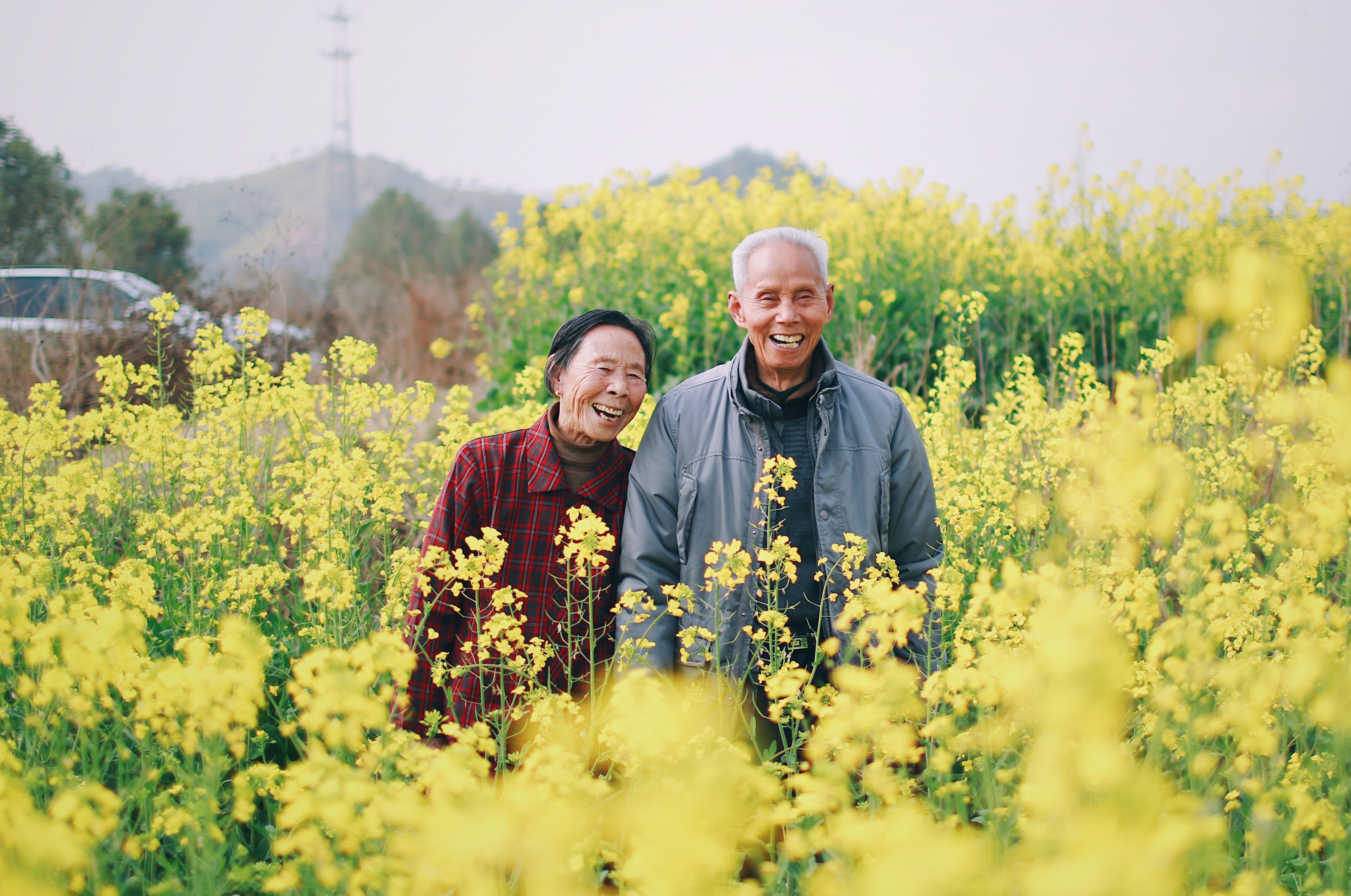 A man and woman surrounded by flowers
